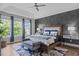 Tranquil primary bedroom showcasing an accent wall, plush bedding, and abundant natural light at 909 Green Oaks Pkwy, Holly Springs, NC 27540