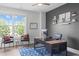 Home office space includes an modern desk, ceiling fan, and large bright window at 909 Green Oaks Pkwy, Holly Springs, NC 27540