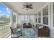 Inviting screened porch with comfortable seating, ceiling fan, and views of the surrounding landscape at 909 Green Oaks Pkwy, Holly Springs, NC 27540