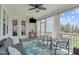 Relaxing screened porch with cozy furniture, ceiling fan, and outdoor views at 909 Green Oaks Pkwy, Holly Springs, NC 27540