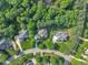 An aerial view shows the house nestled on a tree-lined street with impeccably manicured lawns at 102 Bosswood Ct, Cary, NC 27518