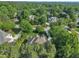 An elevated perspective reveals the house and neighborhood surrounded by dense, mature trees at 102 Bosswood Ct, Cary, NC 27518