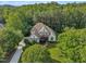 A serene aerial shows the house nestled among lush greenery and manicured lawns at 102 Bosswood Ct, Cary, NC 27518