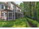 Spacious backyard with a screened-in porch, patio, and lush landscaping and private wooded views at 102 Bosswood Ct, Cary, NC 27518