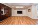 Spacious basement area featuring built-in cabinets, a wet bar, recessed lighting, and hardwood floors at 102 Bosswood Ct, Cary, NC 27518