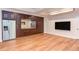 Finished basement with built in cabinets and counter space, stainless fridge, and a large television at 102 Bosswood Ct, Cary, NC 27518