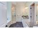 Bright bathroom features granite countertops, dual sinks, a glass shower, and dark tile flooring at 102 Bosswood Ct, Cary, NC 27518