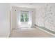 Bedroom featuring an accent wall with a mural of a tree with pink flowers at 102 Bosswood Ct, Cary, NC 27518