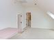 This spacious bonus room features neutral carpet and access to other areas of the home at 102 Bosswood Ct, Cary, NC 27518
