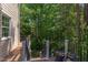 A tranquil deck with flower pots offers a serene view of the lush, wooded landscape at 102 Bosswood Ct, Cary, NC 27518