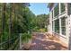 A spacious deck features black metal railing, potted ferns, and siding that complements the natural surroundings at 102 Bosswood Ct, Cary, NC 27518