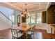 Elegant dining room features a stylish chandelier, wainscoting, and a large wood table at 102 Bosswood Ct, Cary, NC 27518