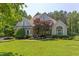 Charming home featuring stone accents, manicured lawn, and mature trees for enhanced curb appeal at 102 Bosswood Ct, Cary, NC 27518