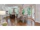 Spacious kitchen with white cabinetry, island, and eat-in area with large windows at 102 Bosswood Ct, Cary, NC 27518