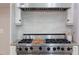 Close up of a Viking gas range with stainless steel hood and white tile backsplash at 102 Bosswood Ct, Cary, NC 27518