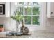 Kitchen detail showcases granite countertops, white cabinets, and a window offering a view of the outdoors at 102 Bosswood Ct, Cary, NC 27518
