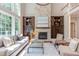Open-concept living room with stone fireplace, hardwood floors, and plenty of natural light at 102 Bosswood Ct, Cary, NC 27518