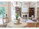 Open-concept floor plan with living room and dining area with a stone fireplace at 102 Bosswood Ct, Cary, NC 27518