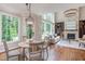 Open floor plan with dining area and living room with stone fireplace at 102 Bosswood Ct, Cary, NC 27518