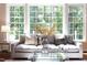 Comfortable living room with a gray sofa, decorative pillows, and a clear glass coffee table at 102 Bosswood Ct, Cary, NC 27518