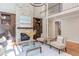 Spacious living room with stone fireplace, hardwood floors, and access to the upper level at 102 Bosswood Ct, Cary, NC 27518