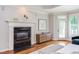 Main bedroom features hardwood floors, fireplace, and plenty of natural light at 102 Bosswood Ct, Cary, NC 27518