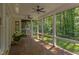 Charming screened-in porch with tiled floors, ceiling fans, and views of the landscaped backyard at 102 Bosswood Ct, Cary, NC 27518
