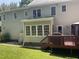 Exterior view of the back of the house with a large deck and sunroom at 104 Belle Isle Ct, Cary, NC 27513