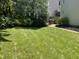 Well-maintained backyard with lush green lawn and manicured landscaping at 104 Belle Isle Ct, Cary, NC 27513