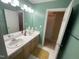 Well-lit bathroom with double sinks, full mirror and view into separate wash room at 104 Belle Isle Ct, Cary, NC 27513