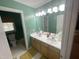 Bright bathroom featuring double sinks, full mirror and view into separate wash room at 104 Belle Isle Ct, Cary, NC 27513