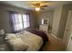 This bedroom features neutral walls, a ceiling fan, and a comfortable bed with purple accents at 104 Belle Isle Ct, Cary, NC 27513