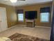 Bonus room with wall-mounted TV, side table, and natural light from the multiple windows at 104 Belle Isle Ct, Cary, NC 27513