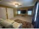 This room features a recliner, a tv, a ceiling fan and lots of light from multiple windows at 104 Belle Isle Ct, Cary, NC 27513