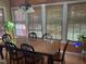 Traditional dining room with wood table, six chairs, and large windows with natural light at 104 Belle Isle Ct, Cary, NC 27513