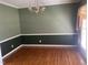 Empty dining room with wood floors, decorative molding, and chandelier, awaiting personal touches at 104 Belle Isle Ct, Cary, NC 27513