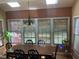 Sunlit dining area with a dark chandelier and large windows providing ample natural light at 104 Belle Isle Ct, Cary, NC 27513