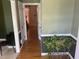 Hallway featuring hardwood floors, decorative plant, and an open doorway leading to another room at 104 Belle Isle Ct, Cary, NC 27513