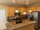 Kitchen featuring granite countertops, stainless steel appliances, and wooden cabinets at 104 Belle Isle Ct, Cary, NC 27513