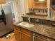 Kitchen featuring granite countertops, a stainless steel refrigerator and ample cabinet space at 104 Belle Isle Ct, Cary, NC 27513