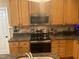 Kitchen featuring granite countertops, stainless steel appliances, and wooden cabinets at 104 Belle Isle Ct, Cary, NC 27513