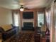 Comfortable living room with fireplace, dark wood furniture, and natural light from large windows at 104 Belle Isle Ct, Cary, NC 27513
