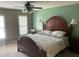 Spacious main bedroom with decorative rug, lots of light and dark wood furniture at 104 Belle Isle Ct, Cary, NC 27513
