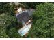 Aerial view of large house featuring a pool, patio, deck, and surrounding greenery at 105 Woodsage Way, Cary, NC 27518