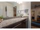 Bathroom vanity with granite countertop, undermount sink, dark wood cabinets, and silver hardware at 105 Woodsage Way, Cary, NC 27518