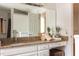 Bathroom featuring a granite countertop vanity, large mirror, and decorative accents, creating a welcoming space at 105 Woodsage Way, Cary, NC 27518