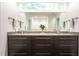 Bathroom featuring granite countertops, double sinks, and dark cabinets at 105 Woodsage Way, Cary, NC 27518