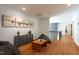 Open bonus room features wood floors, modern furniture, and airplane art at 105 Woodsage Way, Cary, NC 27518