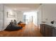 Spacious bonus room features wood floors, comfortable seating, and modern art at 105 Woodsage Way, Cary, NC 27518