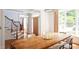 Dining room with a large wooden table, stairs, hardwood flooring, and natural light at 105 Woodsage Way, Cary, NC 27518